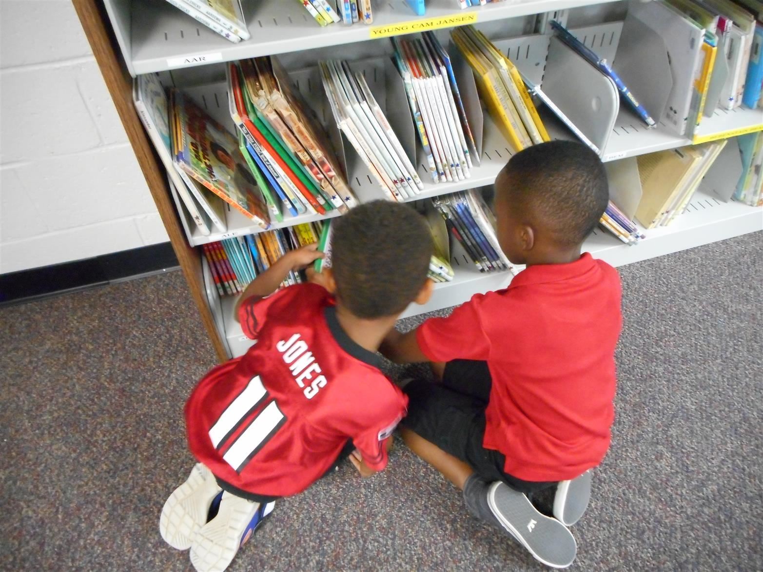 Kids choosing a book in the media center