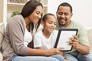 Family seated together using a tablet device