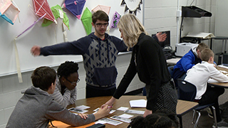 Teacher has small group discussion with students
