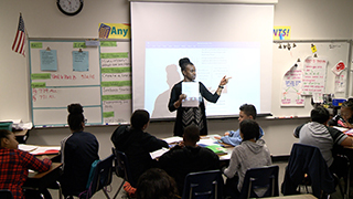  Teacher teaching math in front of classroom