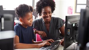 teacher and student at a computer