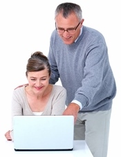 Elderly couple looking at a computer