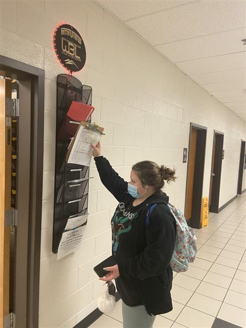 Students checking out to leave for work at the WBL station outside of Rainge's classroom
