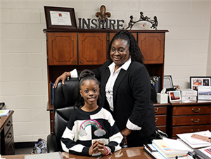 Centerville ES student and Principal for a Day, Aila with Principal Banks