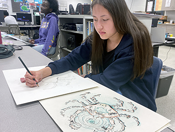 Maxwell student drawing in art class