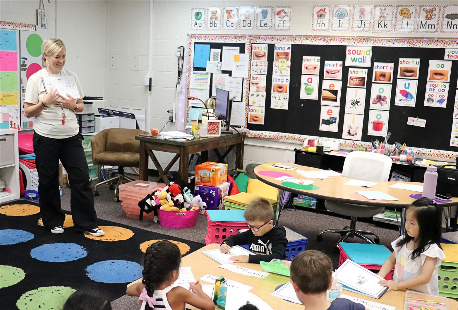 Amber Vallenger stands with her Kindergarten class