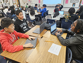 Trickums students working on laptops