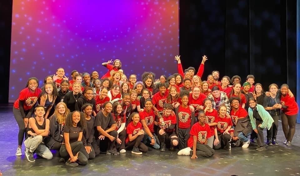  students posing for picture onstage