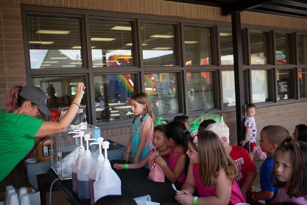 Fund raiser winners enjoying snow cones at the Fun Run party. Fund raiser winners enjoying snow cones at the Fun Run party.
