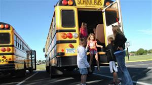 This is a picture of students evacuating a school bus through the rear exit.  