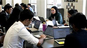 Students collaborating with laptops