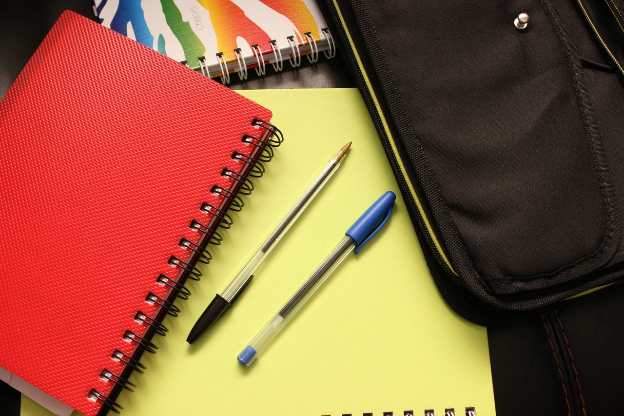Binder, pencil, and blank notebook