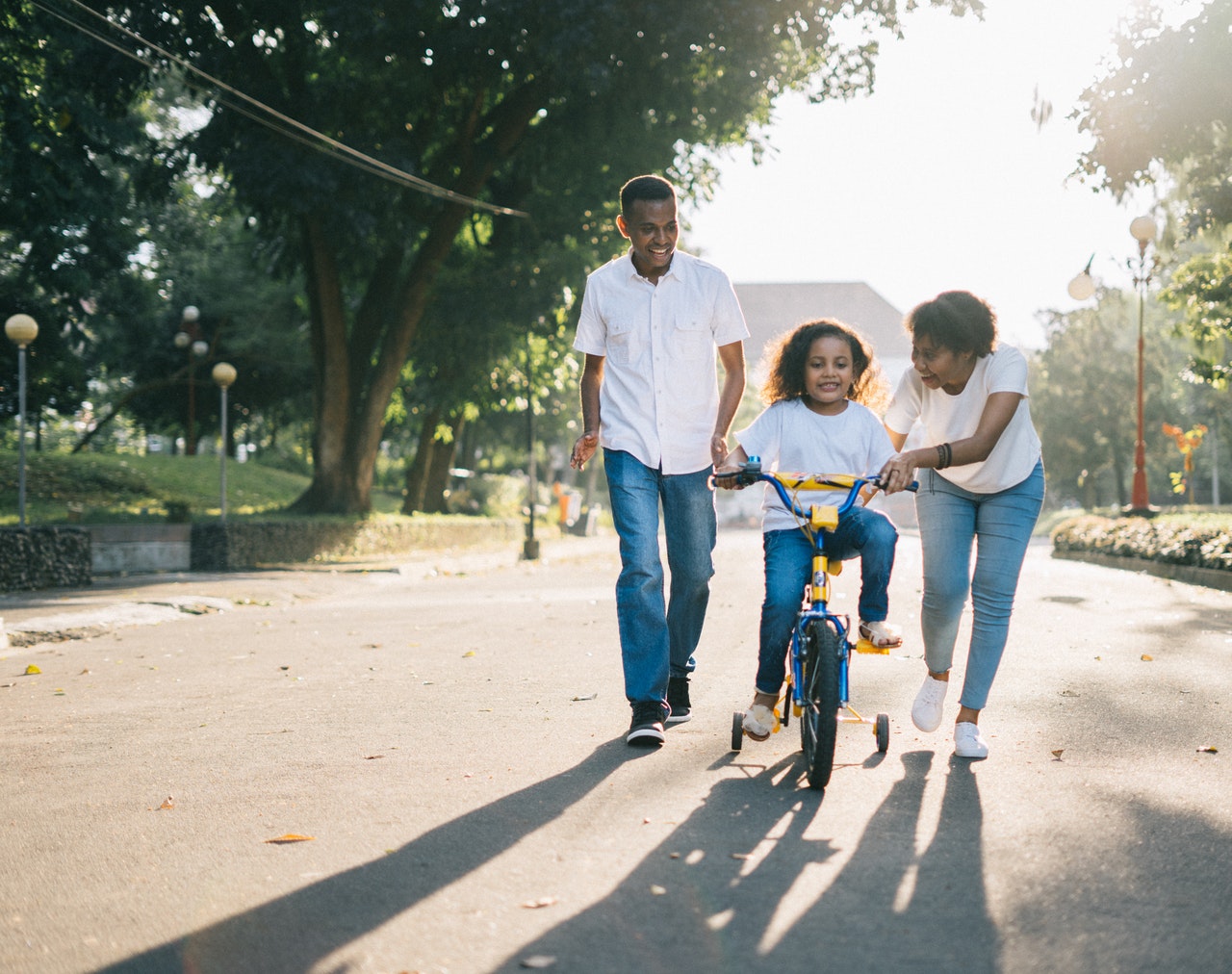 mother, father, and child on bicycle
