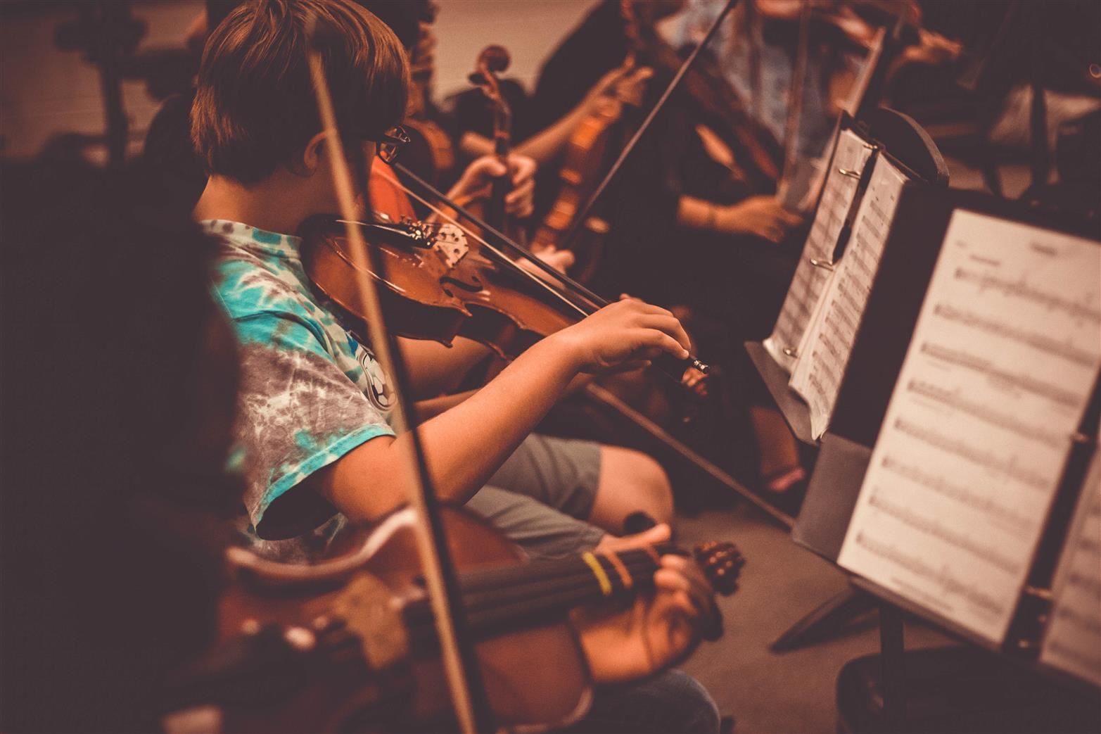 Student playing orchestra instruments 