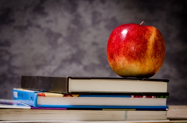 Apple sitting on books Apple sitting on books