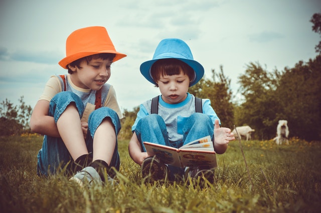 boys reading in field boys reading in field