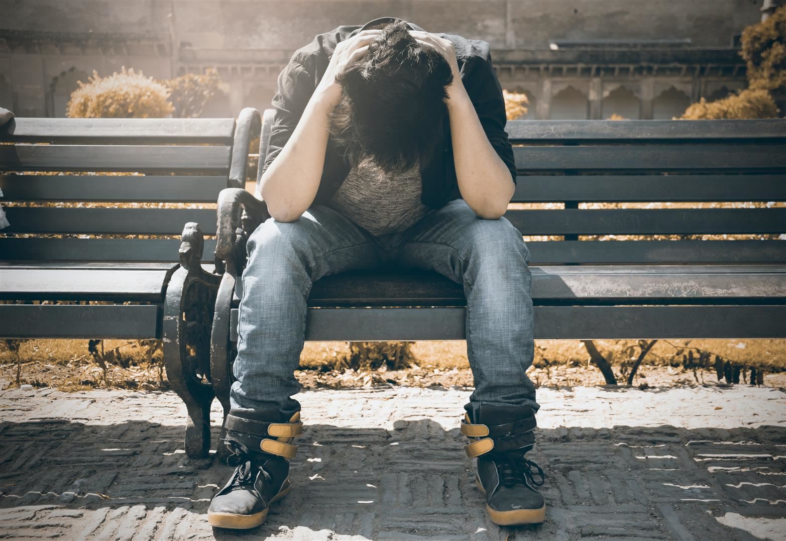 man grieving on bench man grieving on bench